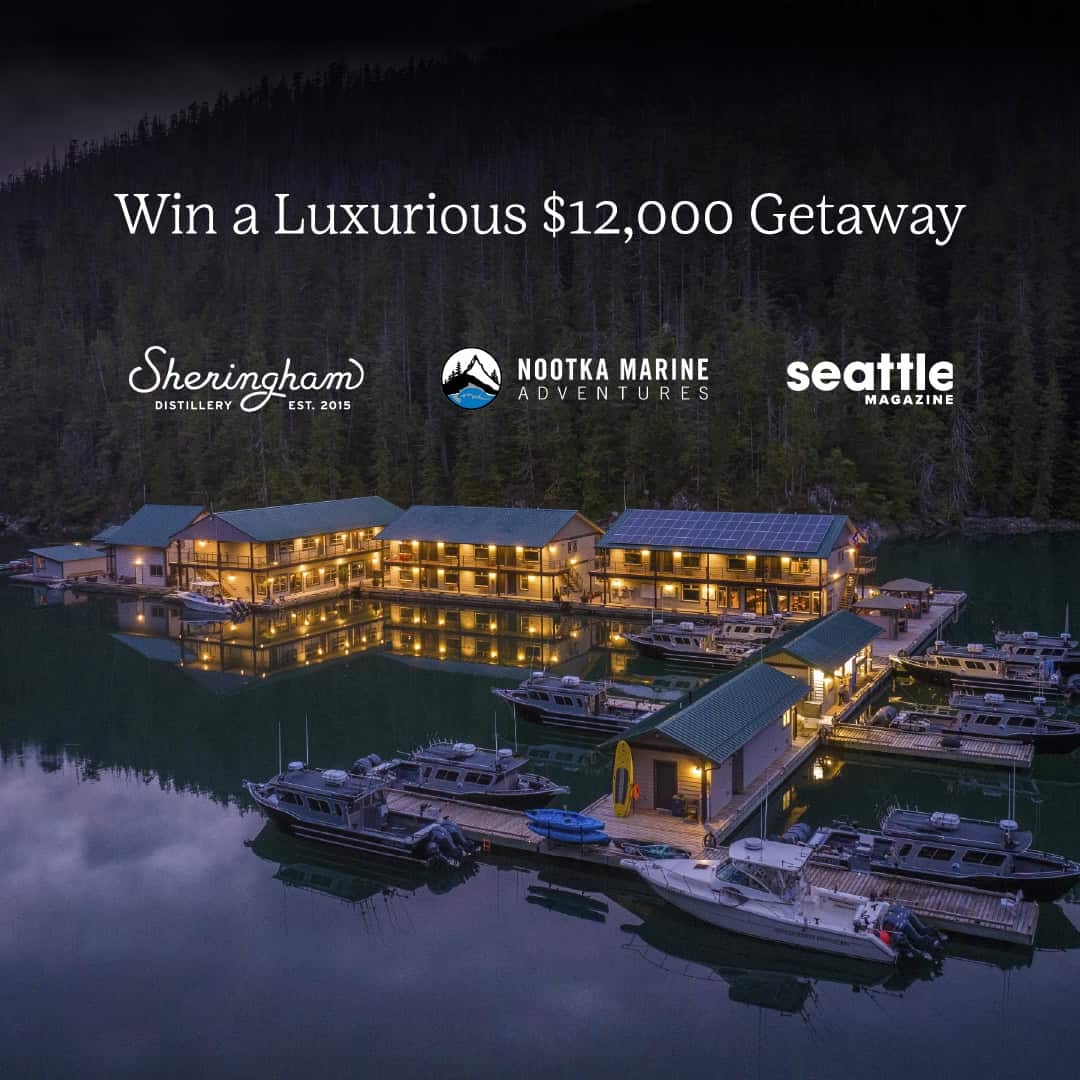         Image of a serene lakeside resort promoting a $12,000 getaway contest on Vancouver Island. Logos of Sheringham Distillery, Nootka Marine Adventures, and Seattle Magazine are shown.