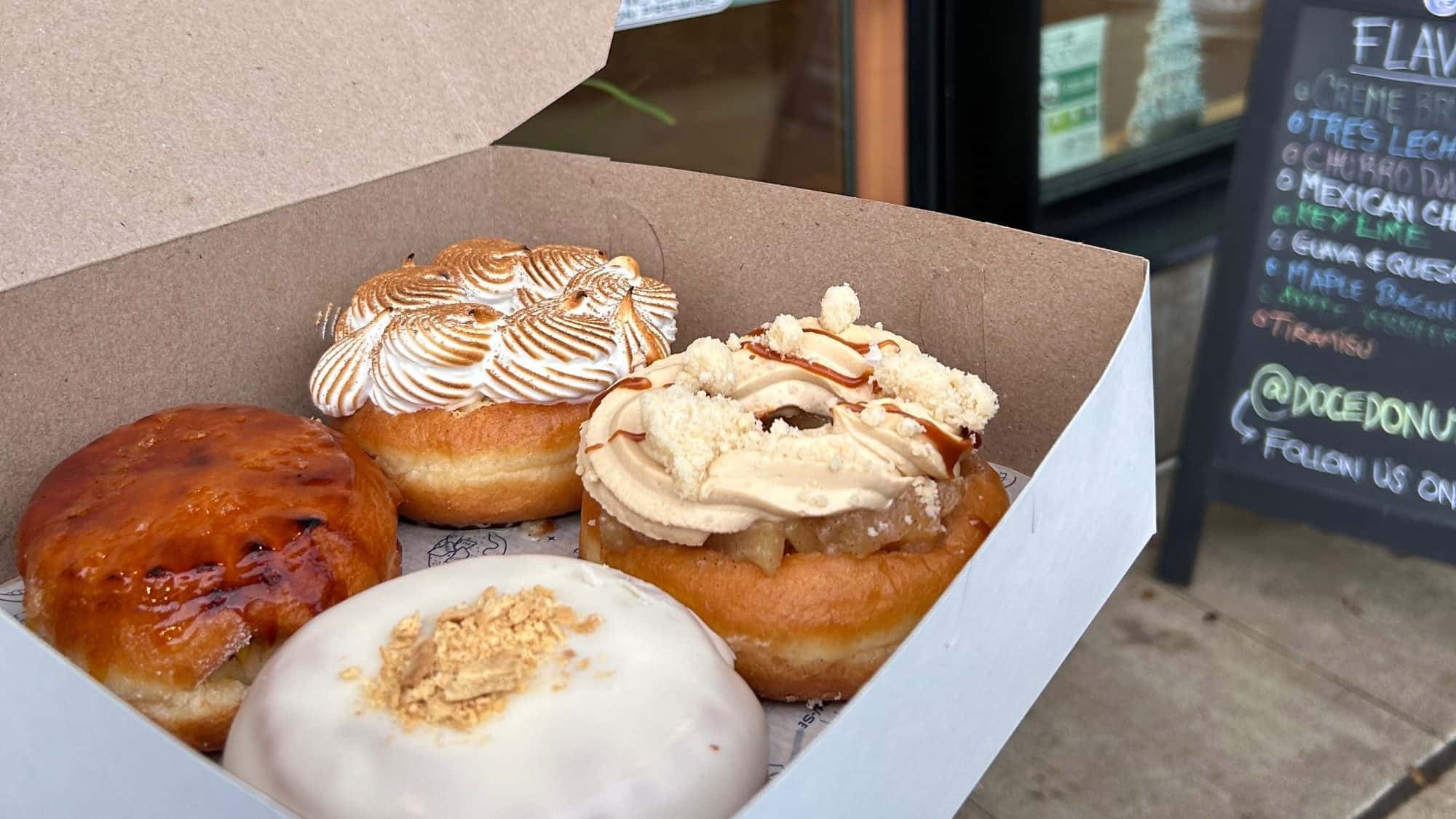 Doce doughnuts: tres leches, apple cobbler, guava + cheese, and passion fruit crème brulee.