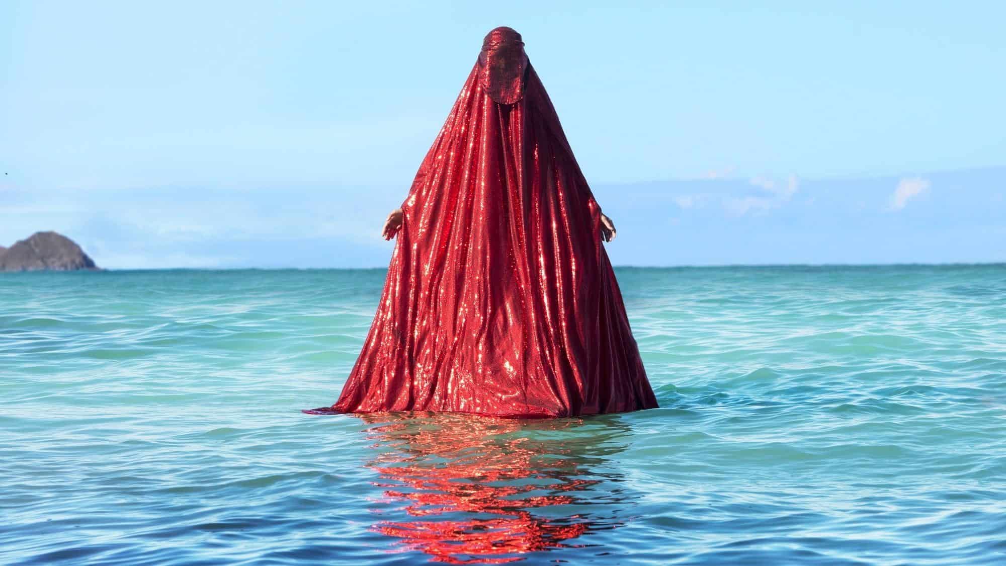 Water Birth, The Red Chador: Genesis I, Kaiona Beach, Oahu, Usa, 2019, Anida Yoeu Ali, Cambodian American, B. 1974, Archival Inkjet Print, Image Courtesy Of The Artist, © Studio Revolt