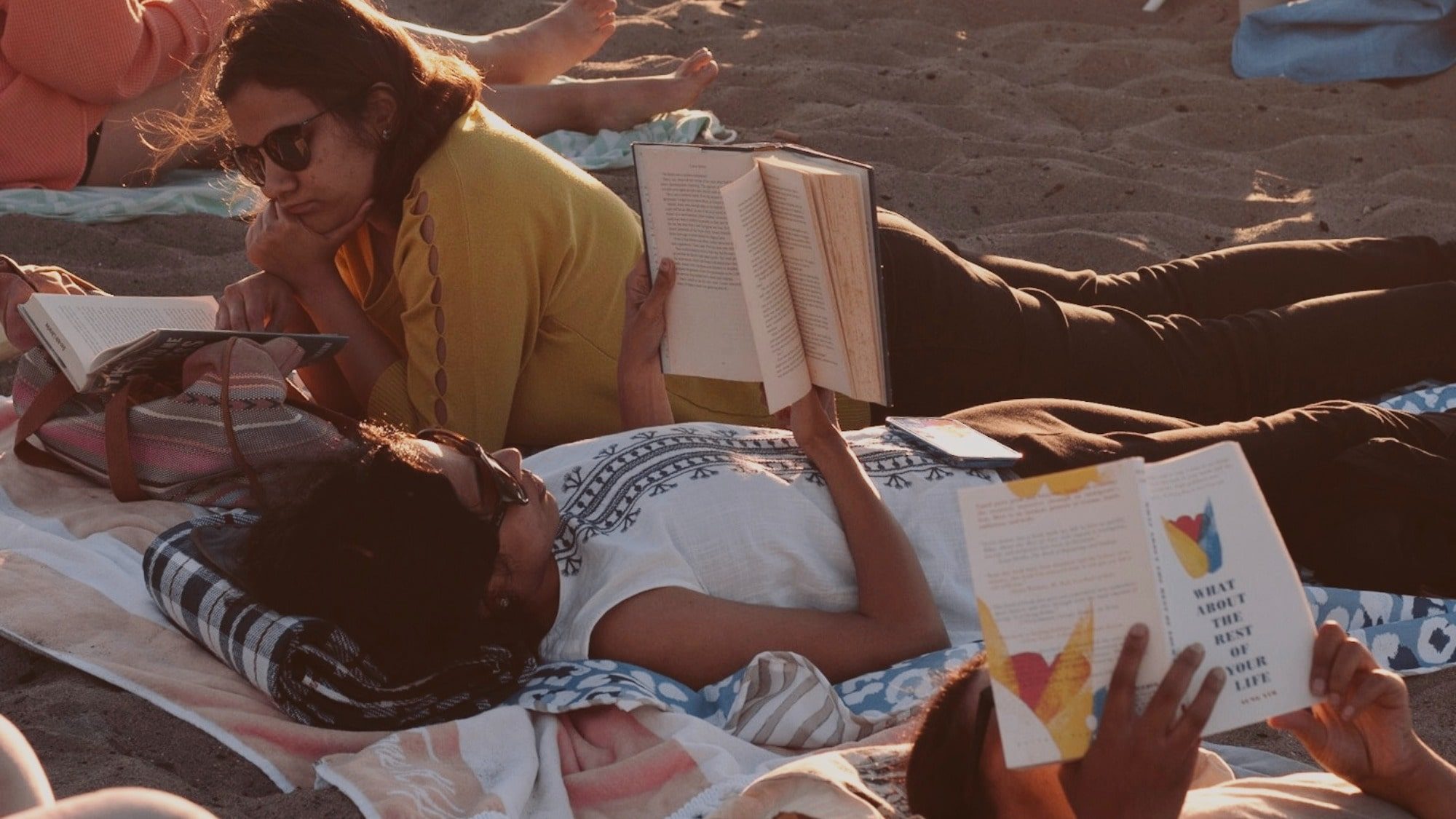 People reading books at the beach