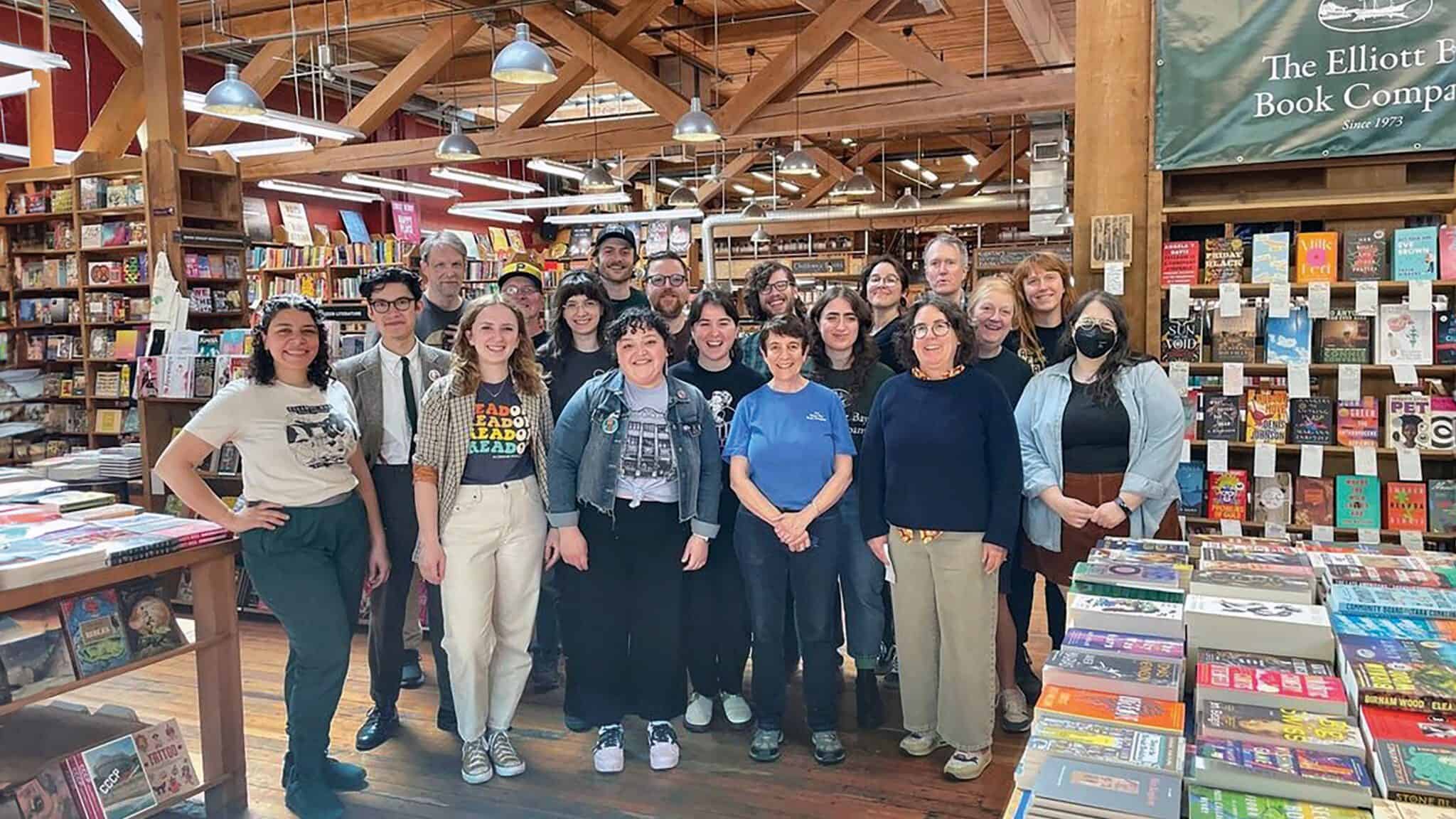 A diverse group of staff at Elliott Book Company getting ready for Independent Bookstore Day