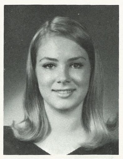 Black and white yearbook photo of a young actress with shoulder-length hair, smiling at the camera.