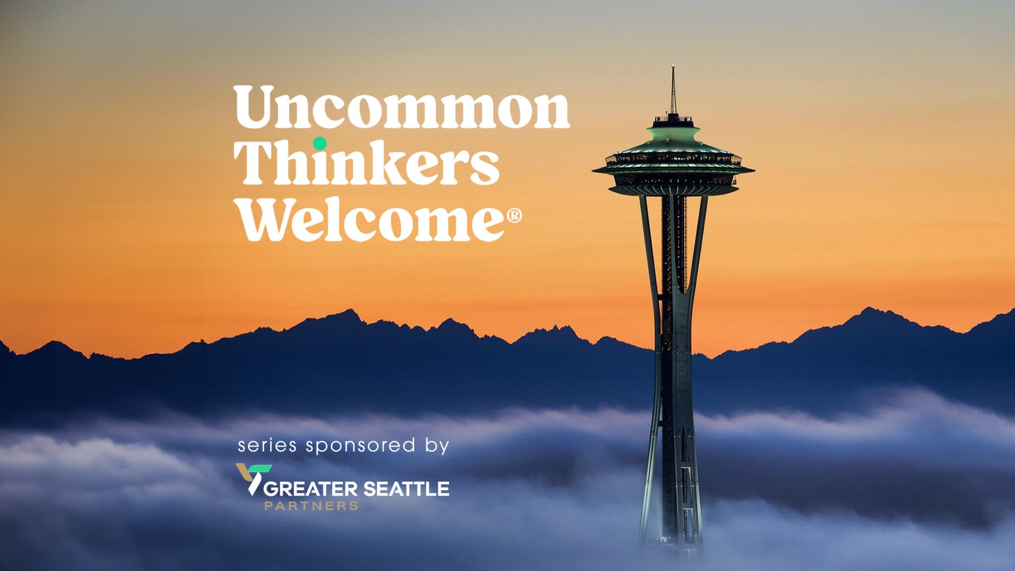 The Space Needle, towering above the clouds at sunset, extends a warm welcome with a promotional message for Greater Seattle Partners, celebrating the region's uncommon thinkers.