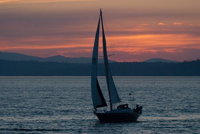 Sailboat at Sunset off Golden Gardens, Seattle, Washington, US